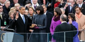 Supreme Court Chief Justice John Roberts administers the oath of office to President Barack Obama, who places his hand on the Bibles of the Rev. Dr. Martin Luther King Jr. and President Abraham Lincoln.