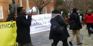 Howard University senior Stanford Fraser, left, leads Death Penalty Repeal Rally in front of the Maryland Statehouse.