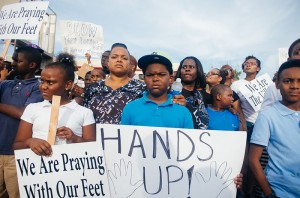 "Hands up! Don't shoot!" signs displayed at Ferguson protests 