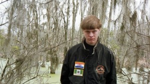 In a Facebook photo, Roof is seen wearing a jacket with two flags: one represents Rhodesia and the other apartheid South Africa. Both were countries white minority rule.