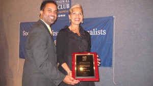 Alumnus Keith Alexander presented the Society of Professional Journalists' award to Carol Dudley for Distinguished Service to Local Journalism.