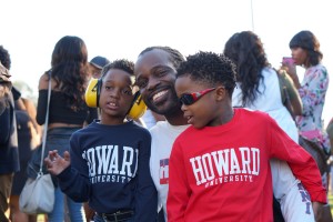 Howard University Alum Daniel Hewitt smiles with his sons as he waits in a food line during the Yardfest Celebration. 